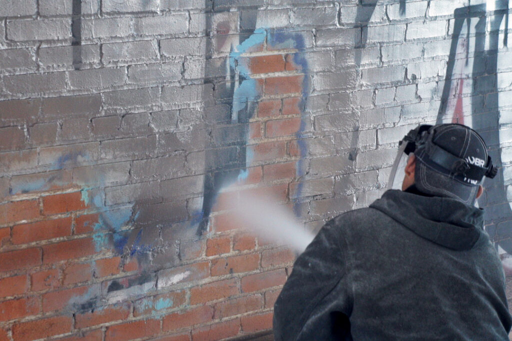 Apartment building new construction brick graffiti paint removal